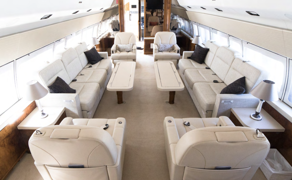 a large white couches and tables in a plane