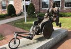 a statue of a man in a wheel chair in a wheelchair