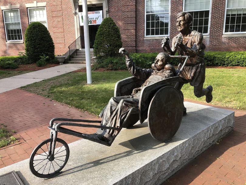 a statue of a man in a wheel chair in a wheelchair