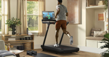 a man running on a treadmill in a living room
