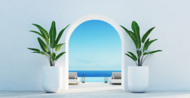 a white archway with plants in it