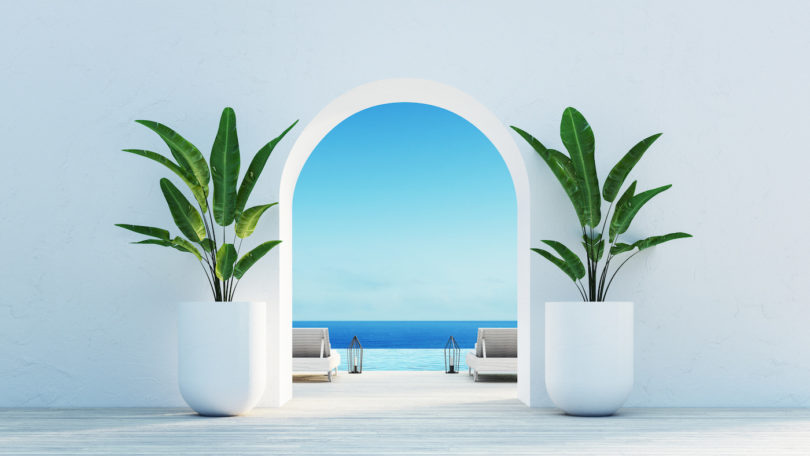 a white archway with plants in it