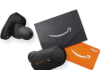 a pair of black earbuds next to an orange card