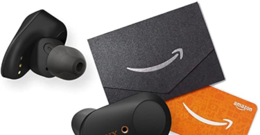 a pair of black earbuds next to an orange card