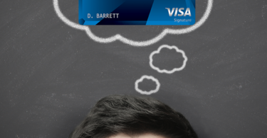 a man looking up at a credit card