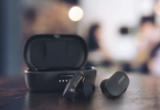 a pair of wireless earbuds on a table