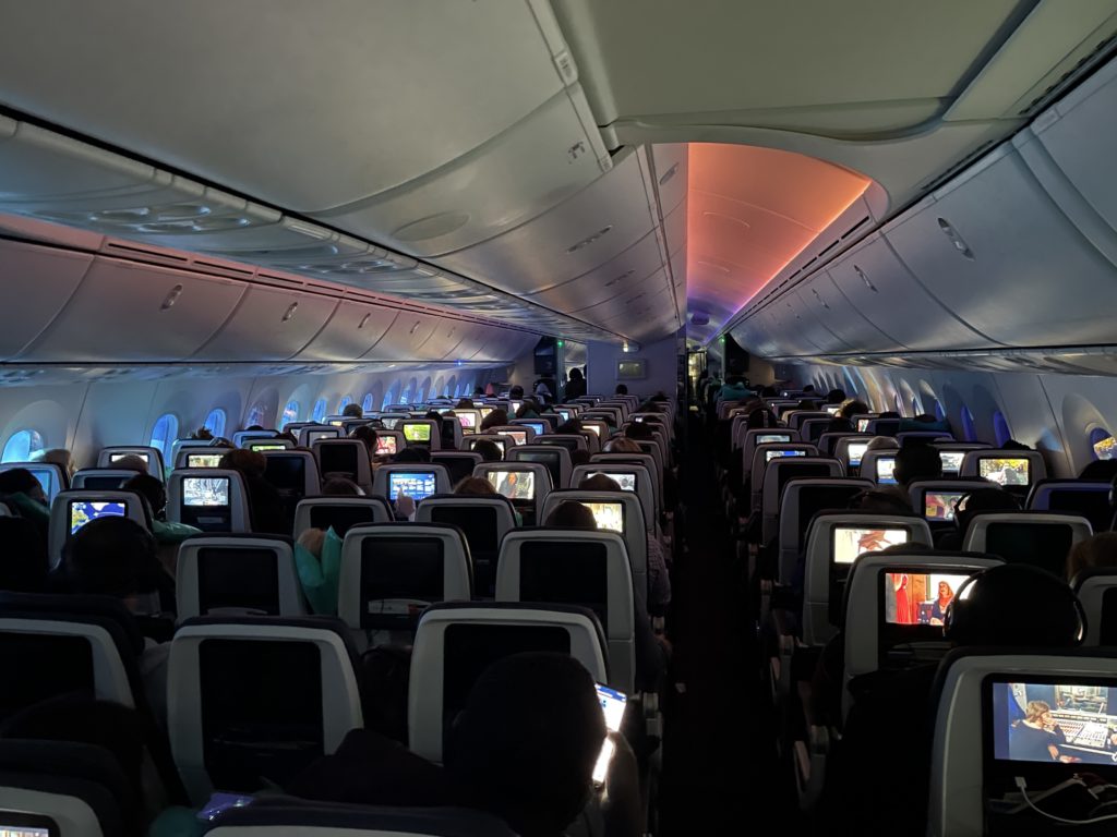 a plane with many seats and a television screen