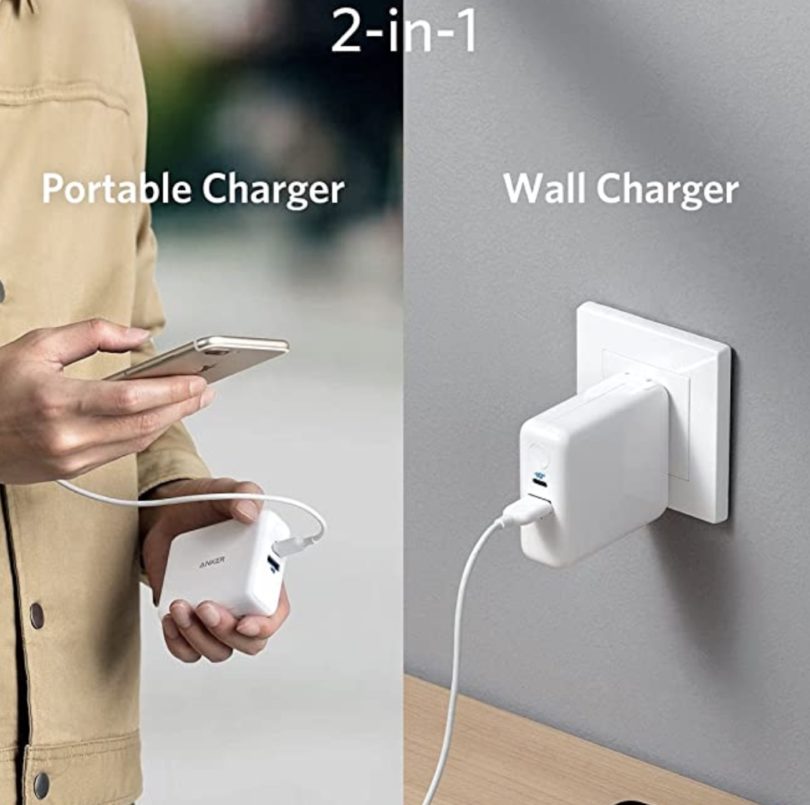 a person holding a phone and charging a wall charger