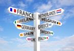 a sign post with different countries/regions