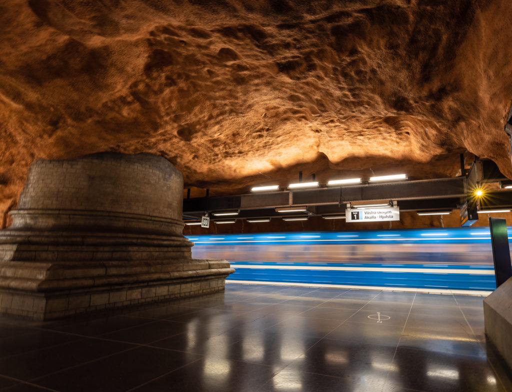 a tunnel with a marble column and a light trails