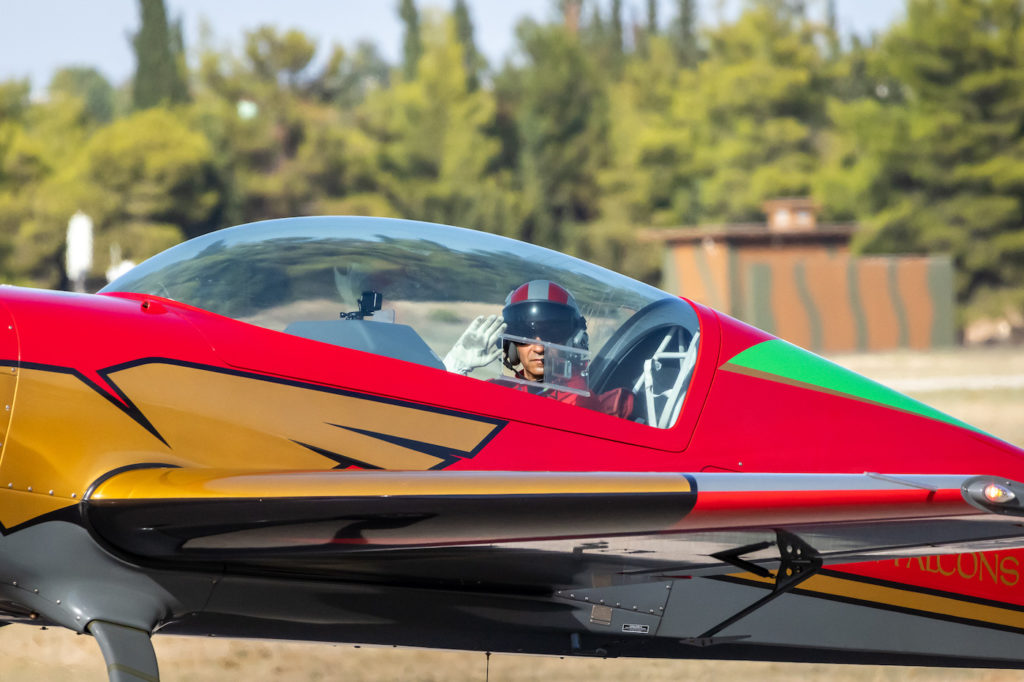 a man in a red and yellow airplane
