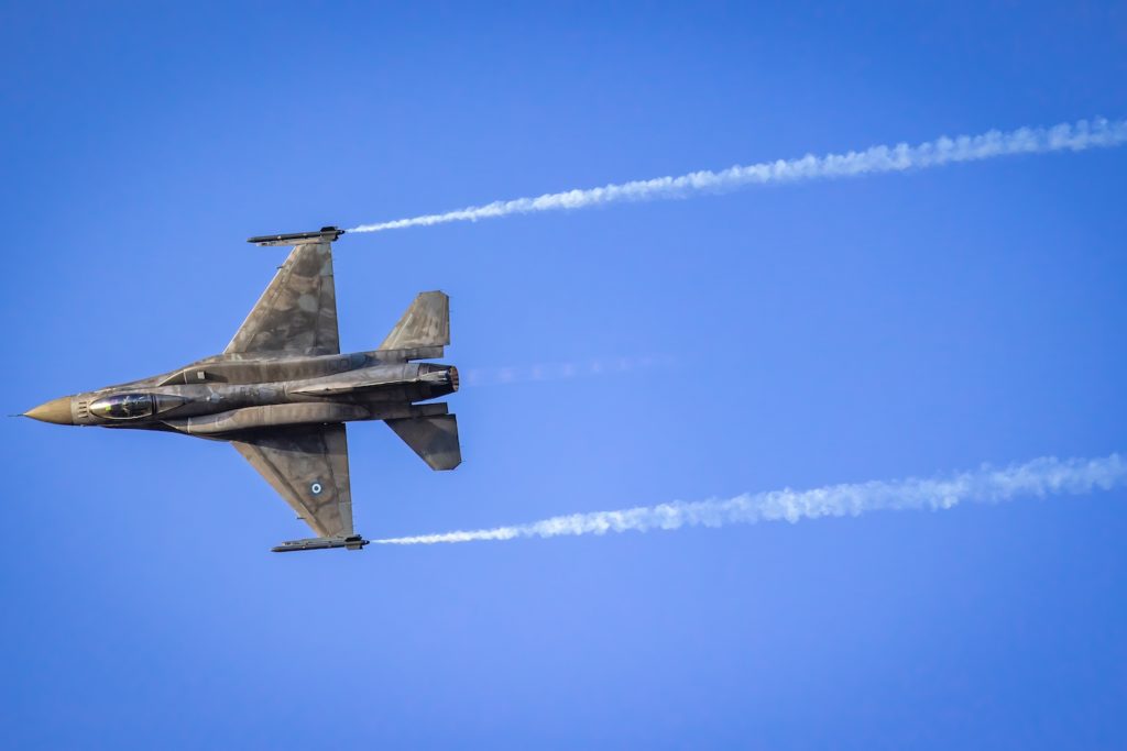 a military jet flying in the sky