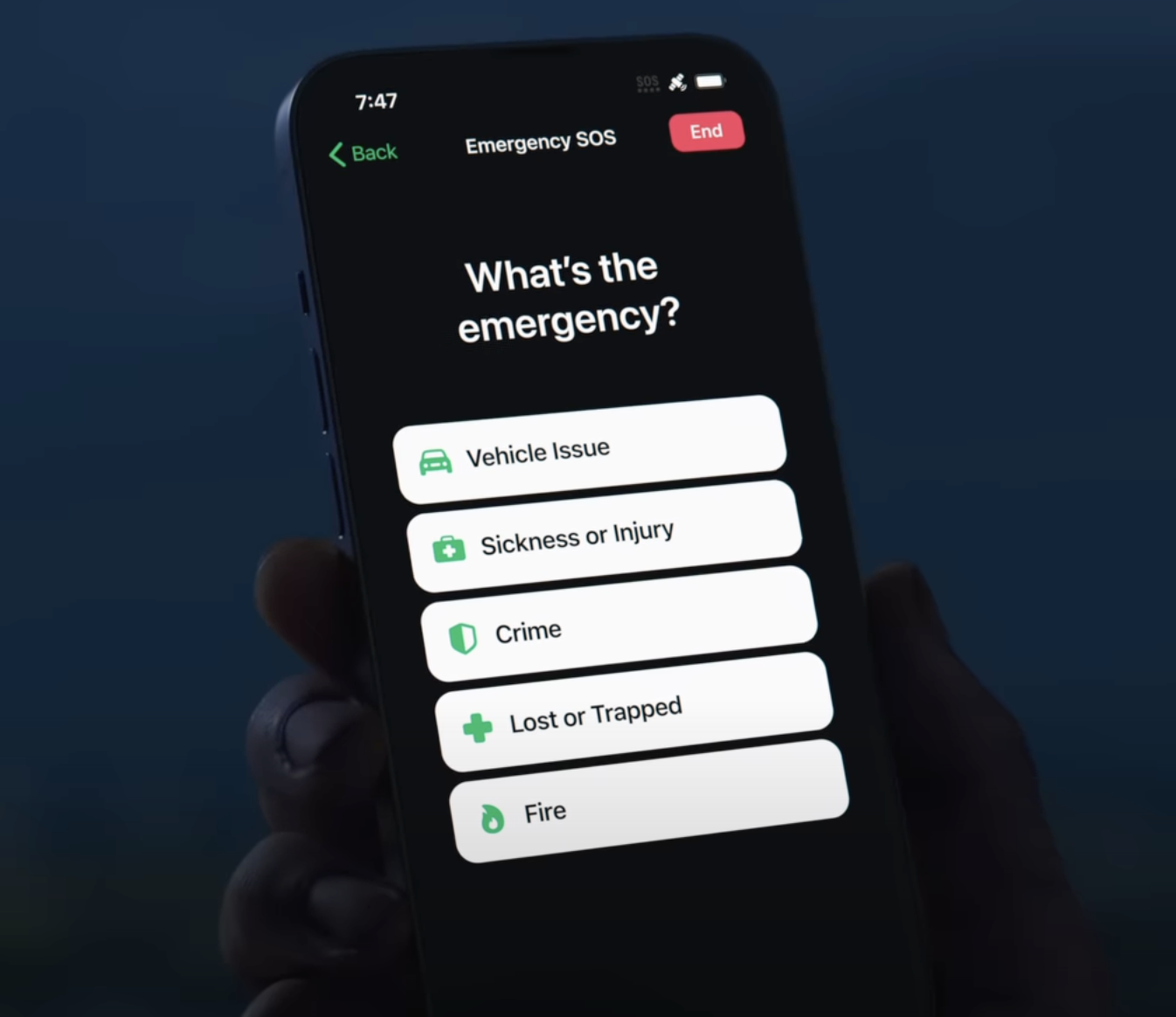 a hand holding a phone with a screen showing emergency