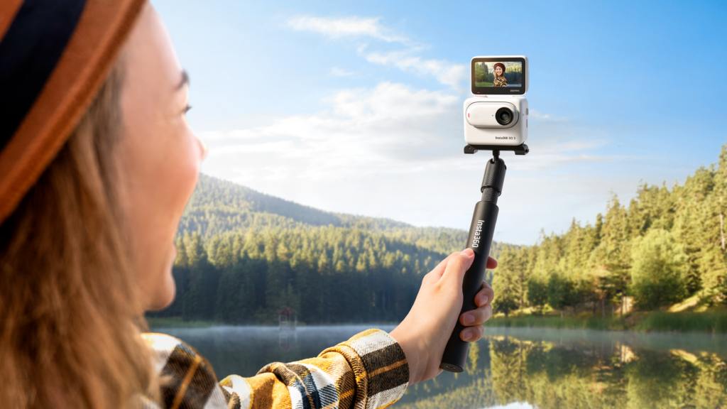 a person holding a selfie stick with a camera on it