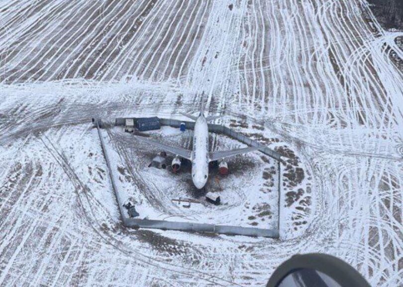 an airplane in a snowy field