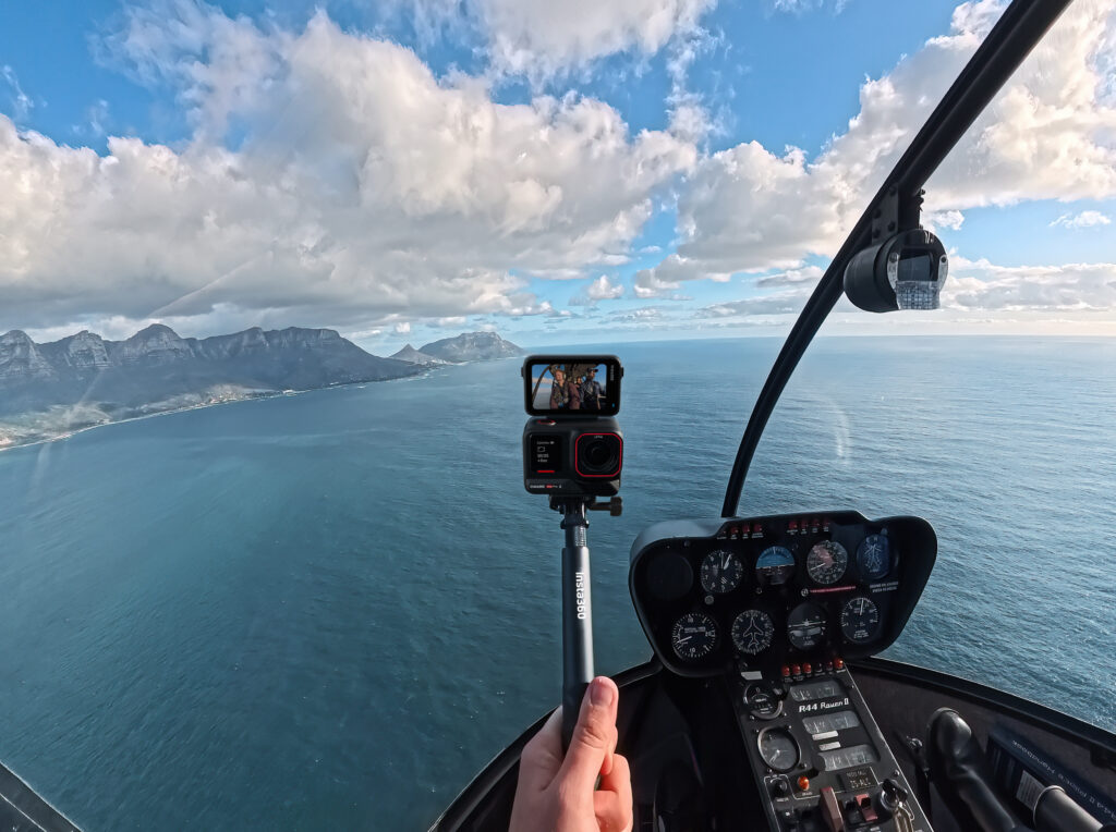 a hand holding a camera in a helicopter insta360 ace pro 2