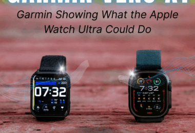 The image features two smartwatches placed on a wooden surface. The left watch displays the time "07:32" with additional icons and information. The right watch also shows "7:32" with various data and colorful indicators. Above the watches, the text reads "GARMIN VENU X1" in large letters, with a subtitle "Garmin Showing What the Apple Watch Ultra Could Do." The background is blurred, highlighting the watches.