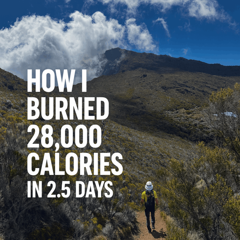 A person wearing a hat and backpack is hiking on a trail through a mountainous landscape with shrubs and a cloudy sky. The text on the image reads, "How I burned 28,000 calories in 2.5 days."