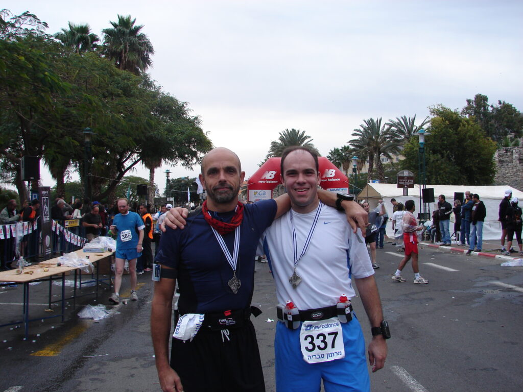 two men standing together in a race