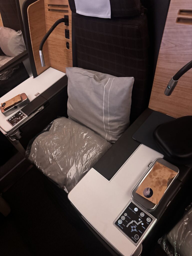 a chair with a pillow and a laptop on it