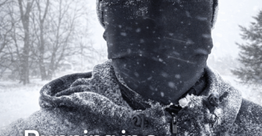 A person is outdoors in a snowy environment, wearing a hat and a face covering. Their eyebrows and eyelashes are frosted. The temperature is indicated as 8 degrees. Text on the image reads: "Running in a Winter Storm: What to Wear, How to Stay Safe, and When to Stay Inside." Snow-covered trees are visible in the background.